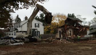 Pasquazzi Bros. demolishes the home at 308 Main Ave. Tuesday morning.