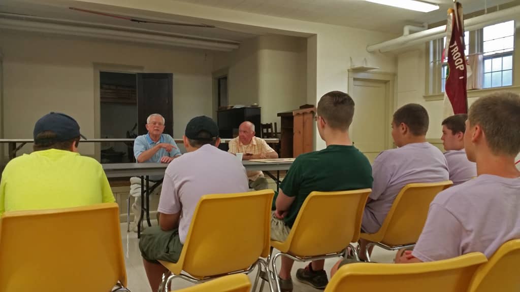 Everett McEwen (blue shirt) and Jack Wallace (orange plaid shirt) told stories and answered questions at a Troop 1 Gaspee Plateau meeting on July 29.