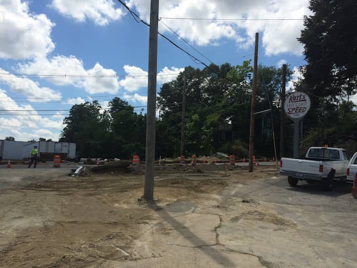 A telephone pole in the center of the access to Karl's East Coast Speed on Post Road.