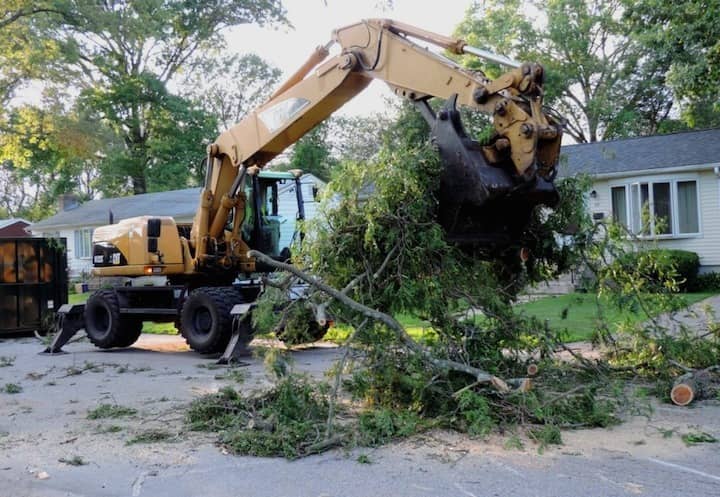 A city cleanup crew uses heavy machinery to clear a downed tree in Lakewood, on South Atlantic Ave.