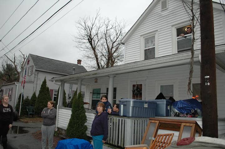 Across the street, neighbors watched firefighters search for the last pockets of flames at 39 Eaton Ave.