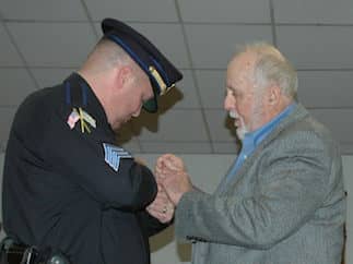 [CREDIT: Rob Borkowski} From left, Sgt. Frank J. McGee is pinned a sergeant by his dad, retired RI State Policeman Frank McGee !!.