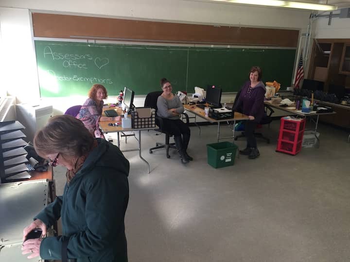 [CREDIT: Rob Borkowski] From left, Jane Murphy, doing research for a law office while visiting the City Hall Annex's temporary home on Draper Avenue in the John Greene Building, as Aylison Jordan, clerk's assistant, Kimberly Souza, clerk's assistant, and Bonnie Hamilton, assessor, look on.