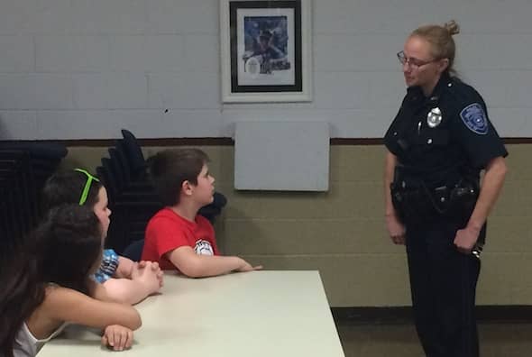 [CREDIT: Rob Borkowski] From left, Lippitt Third Grader Leo Iannelli speaks with Officer Jill Marshall during his visit to the Warwick Police Department May 2.