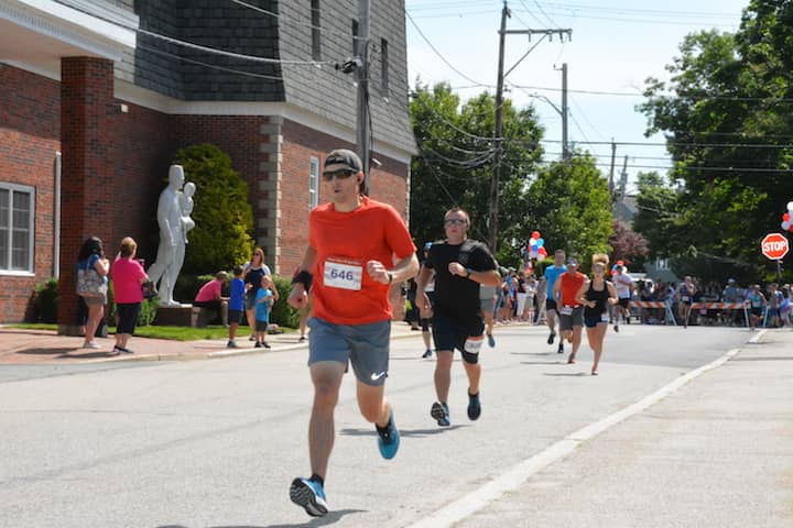 [CREDIT:Rob Borkowski] Matthew Cuddy, 33, of Warwick, nears the finish line at the Gaspee Days 5K Saturday, June 10, 2018. 