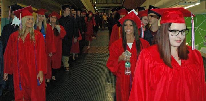 {CREDIT: Rob Borkowski] Toll Gate High's Class of 2019 graduates march toward the CCRI field house for graduation.