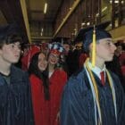 {CREDIT: Rob Borkowski]] In front, Logan Heberg and Morgan Henderson' Center, Kara Hulstein and Calia Howard wait inside CCRI's main building on the ramp to walk in to graduation in the field house.