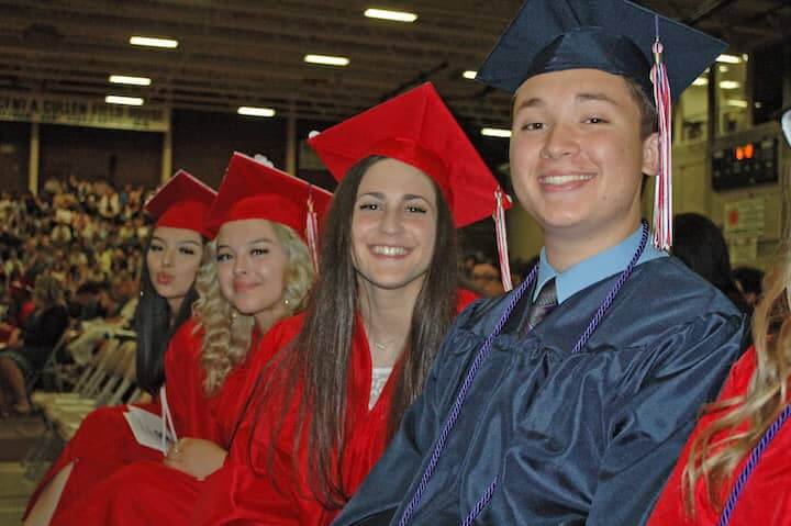  {CREDIT: Rob Borkowski] Front to back, Kyle Wright-Perry, Brittany Wysong, David Yabut, Rebecca Yaseen, and Jaquelin and Jennifer Zuniga wait during graduation at the CCRI field house June 6.