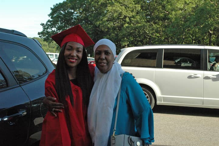 Anisah Syria Abdul-Rashid pauses outside CCRI with her mom, Amiwa, before graduation June 6.