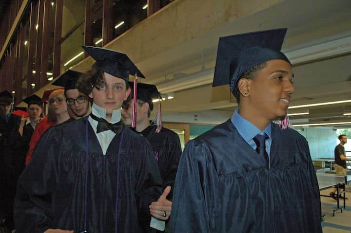 {CREDIT: Rob Borkowski] Aiden Meserve heads toward the CCRI field house for graduation.