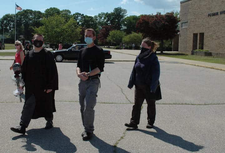 [CREDIT: Rob Borkowski] Pilgrim High 2020 grad Aaron Cole walks into the parking lot at Pilgrim High after receiving his diploma with his dad, Adam and Adam's girlfriend, Joceyln King, June 4, 2020.