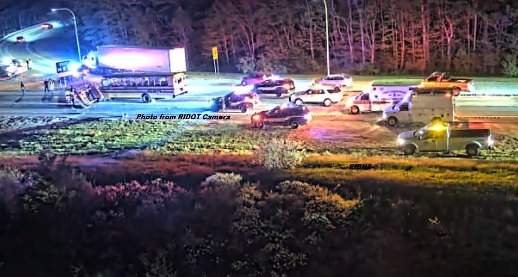 [CREDIT: RIDOT] The following image from a RIDOT camera shared by RI Breaking News Source on Twitter shows the crash scene on Rte. 95 near Rte. 102 in West Greenwich between a WW track bus and an Aetna Bridge Company stake body truck. The crash injured 7, including the bus driver and four members of the track team.