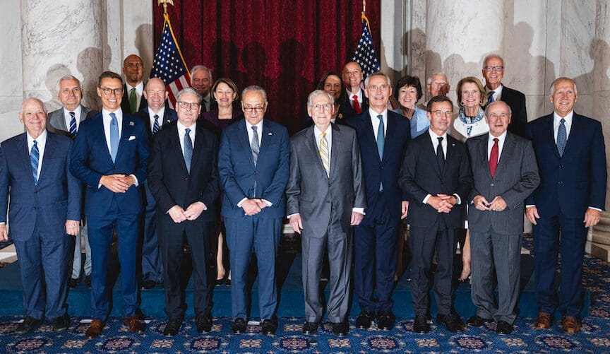 [Sen. Reed's Office] U.S. Sen. Jack Reed, far left, second row, with several Senators at the NATO summit in Washington, DC. At center are Senators Dem. majority leader Chuck Schumer and GOP minority leader Mitch McConnell.