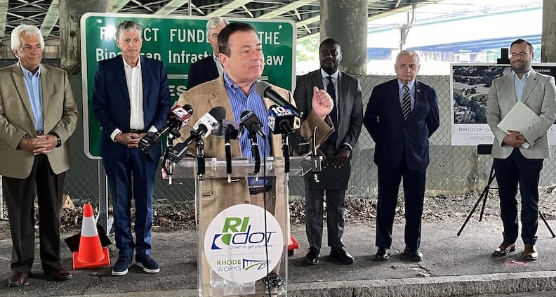 [CREDIT: Speaker Shekarchi's Office] RI Speaker of the House Joseph Shekarchi speaks during a press conference launching the 15 bridges project repairing or replacing spans between Providence and Warwick on Rte. 10 and Rte. 95. Behind him are, from left, Governor Dan McKee, U.S. Sen. Sheldon Whitehouse, Congressman Gabe Amo, and US Sen. Jack Reed.