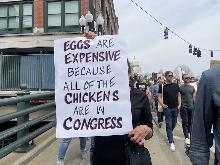 [CREDIT: Rob Borkowski] One sign held among thousands of people gathered at the State House April 19 Hands Off protest against the Trump Administration. 