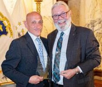 [CREDIT: MHARI] From left, Senate Finance Chairman Louis P. DiPalma and House Environment and Natural Resources Chairman David A. Bennett following the presentation of the Mental Health Association of Rhode Island’s Legislator of the Year awards.