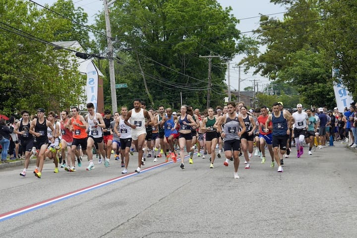 [CREDIT: Laura Paton] Nearly 2200 runners take off from the start line on Saturday for the annual Gaspee Days 5K Foot Race.