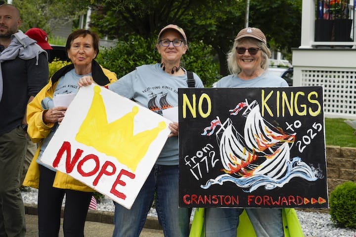 [CREDIT: Laura Paton]  Members of the Cranston Forward group hold up signs during the Gaspee Days parade on Saturday.
