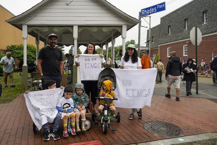 [CREDIT: Laura Paton]  The Marinez and Brown families peacefully demonstrate during the Gaspee Days parade on Saturday.