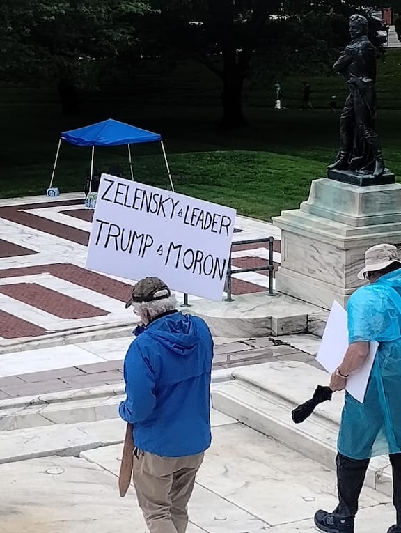 [CREDIT: Jim Taylor] Thousands attended the third 'No Kings' nationwide rally June 14 at the State House. Above, one protestor's political sign compares and contrasts political leaders' foreign policy.