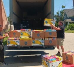 [CREDIT: Lincoln Smith/ Photographic Society of RI] From left, Caden Denton and Jordan Hiatt/Marketplace/Supervisor loading the truck headed to West Bay Marketplace during the Cereal Challenge food drive.