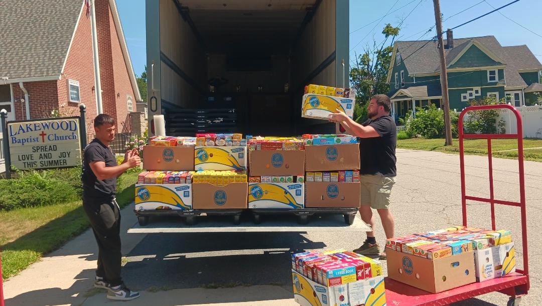 [CREDIT: Lincoln Smith/ Photographic Society of RI] From left, Caden Denton and Jordan Hiatt/Marketplace/Supervisor loading the truck headed to West Bay Marketplace during the Cereal Challenge food drive.