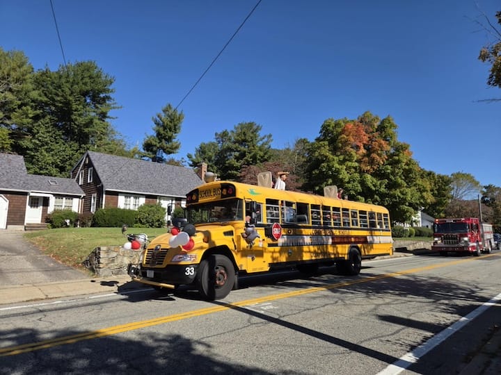 [CREDIT: Mary Carlos] Coventry High Students aboard a bus, followed by a fire engine during the CHS Homecoming parade Oct. 4, 2025