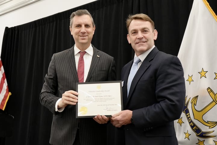 [CREDIT: Katherine Riordan] From Left, Rep. Seth Magaziner and Commander Bob Flynn, USN, Ret., Director of URI's Center for Military and Veteran Education, at the veterans breakfast Monday, Nov. 10, 2025 at Crowne Plaza Warwick.